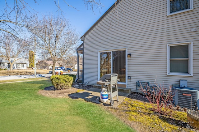 exterior space with a lawn and central air condition unit