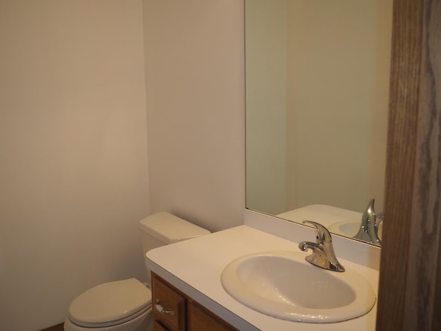 half bath with vanity and toilet