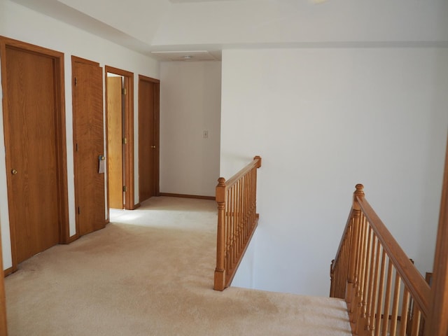 hallway featuring carpet and an upstairs landing