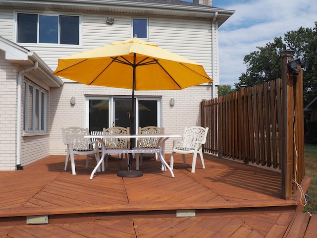 wooden deck featuring fence and outdoor dining space