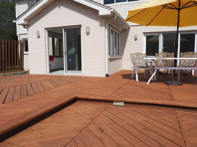 wooden terrace featuring outdoor dining space