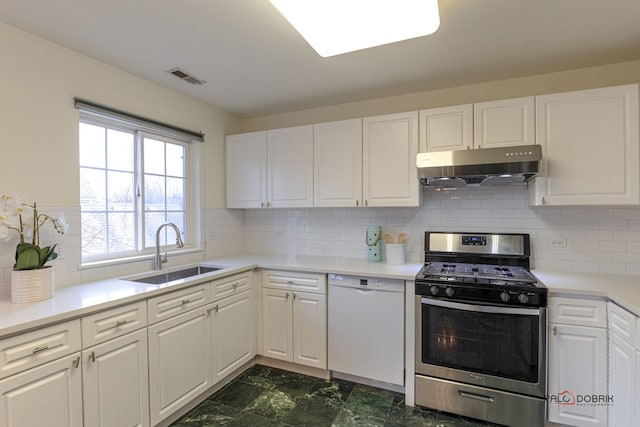 kitchen with white cabinets, white dishwasher, under cabinet range hood, a sink, and gas stove