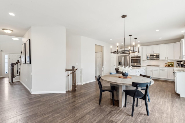 dining area featuring a chandelier, recessed lighting, baseboards, stairs, and dark wood finished floors