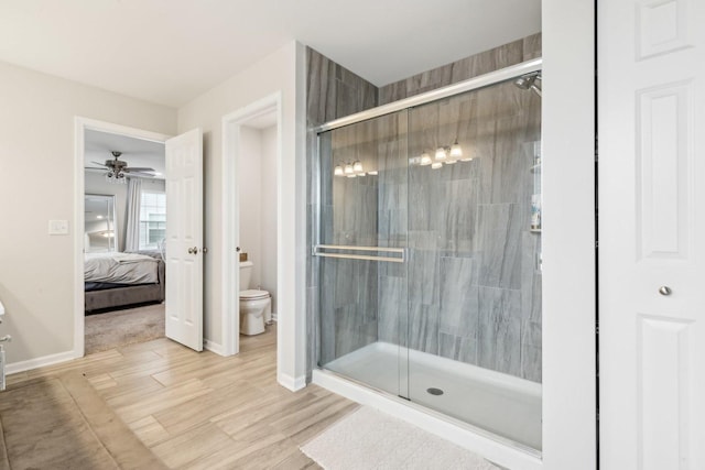 ensuite bathroom with a stall shower, baseboards, ensuite bath, and toilet