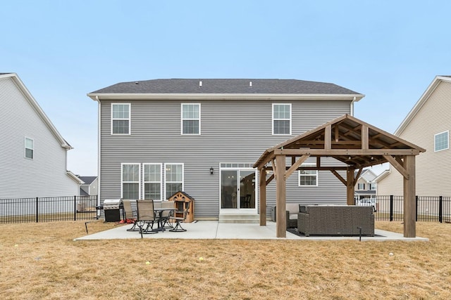 back of house with a patio, outdoor lounge area, a lawn, a gazebo, and a fenced backyard