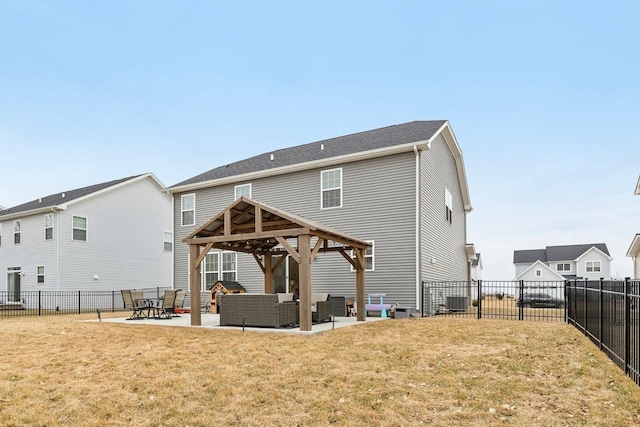 back of house with a lawn, a fenced backyard, a gazebo, a patio area, and an outdoor living space