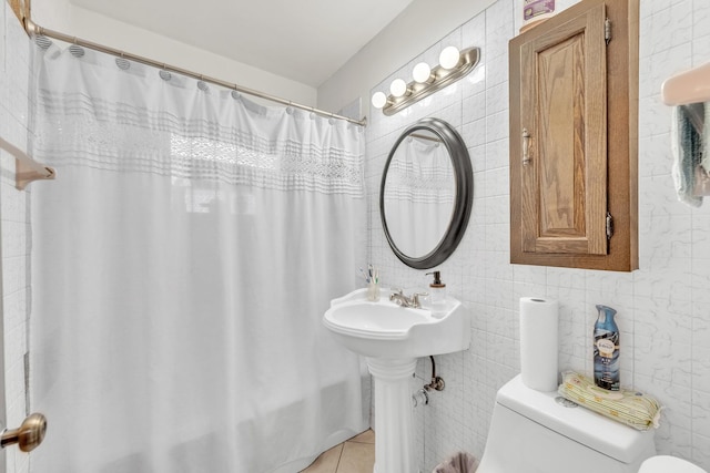 bathroom with toilet, shower / bath combo, tile walls, and tile patterned floors