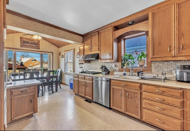 kitchen with stainless steel appliances, light countertops, a sink, and under cabinet range hood