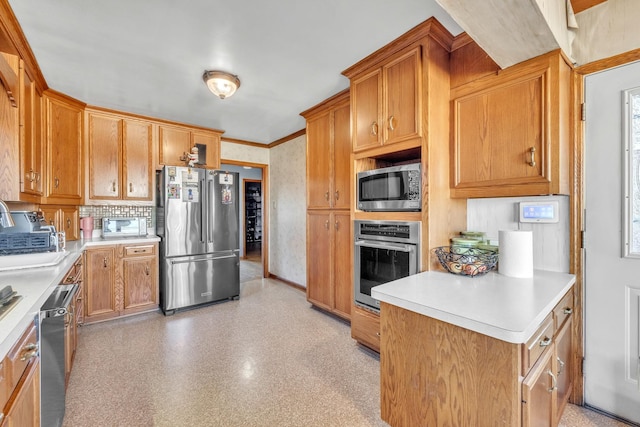 kitchen featuring tasteful backsplash, appliances with stainless steel finishes, brown cabinets, ornamental molding, and light countertops