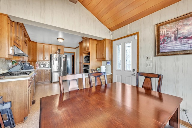 dining room featuring lofted ceiling and wooden ceiling