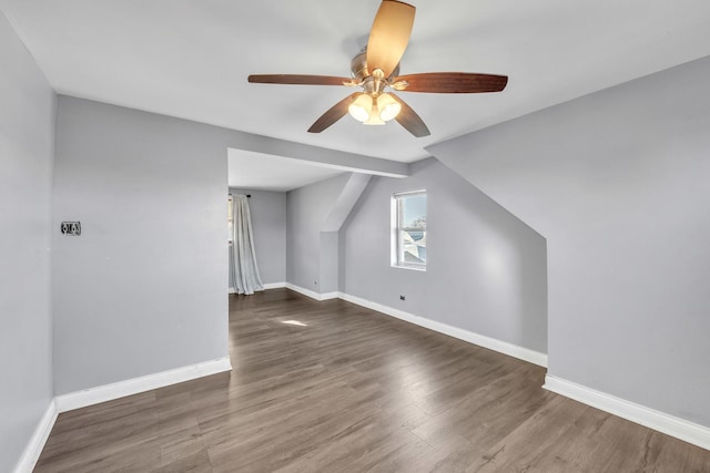 bonus room with ceiling fan, baseboards, and wood finished floors