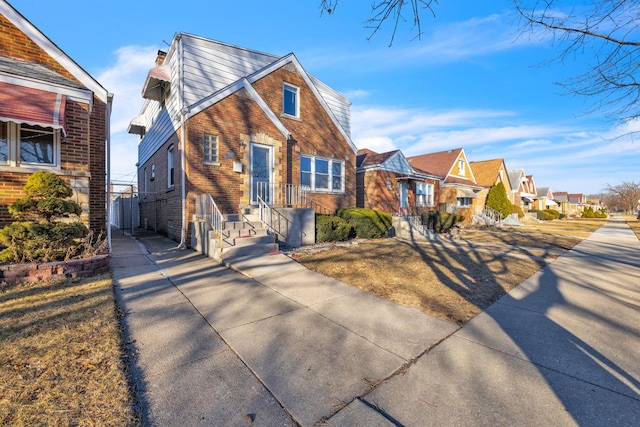 view of front of property with a residential view and brick siding