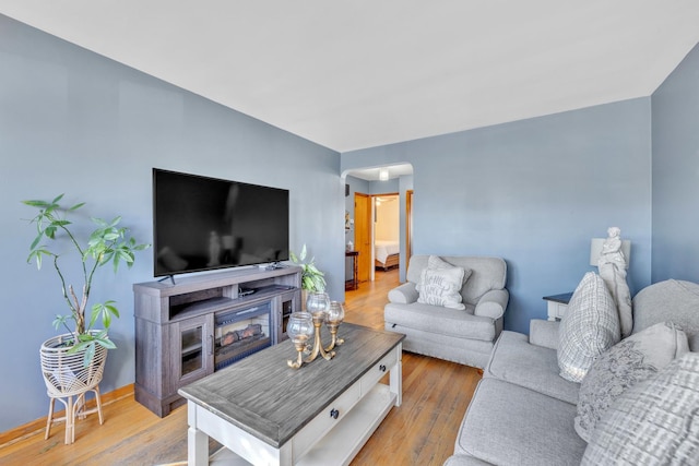 living area featuring wood finished floors and baseboards