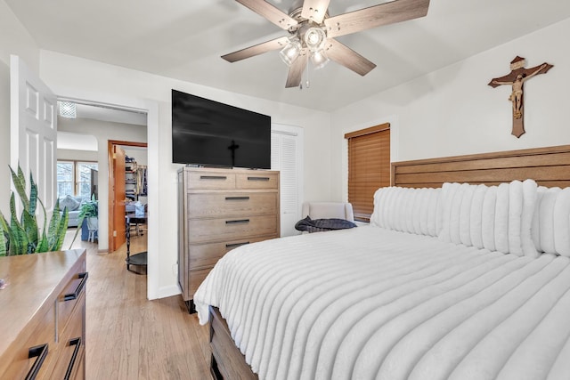 bedroom featuring light wood finished floors and a ceiling fan