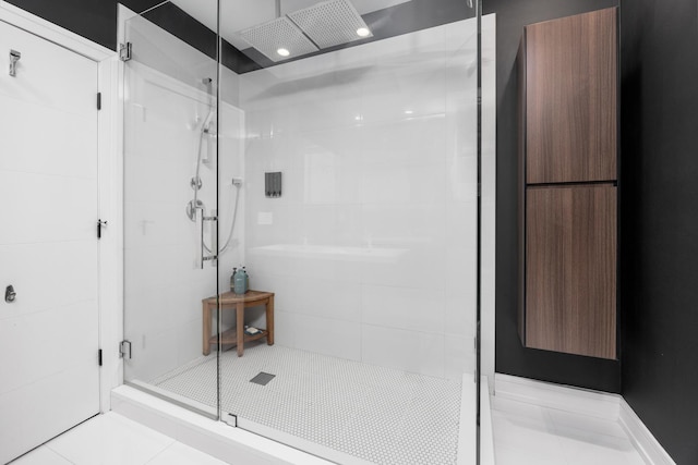 full bath with a shower stall and tile patterned flooring