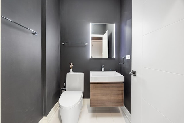 bathroom featuring toilet, tile patterned flooring, and vanity