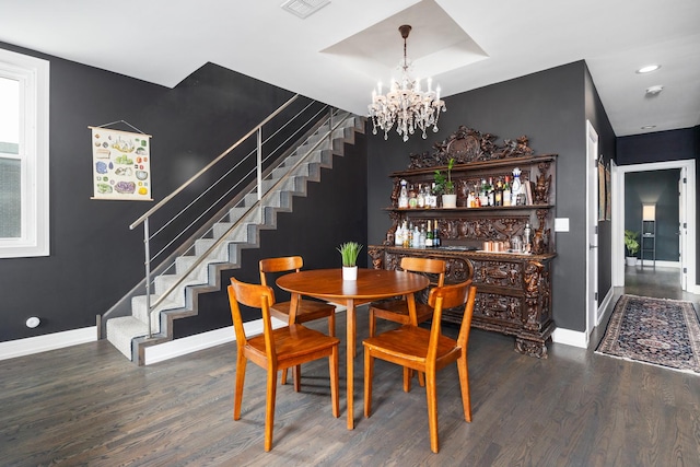 dining room featuring stairs, an accent wall, and wood finished floors