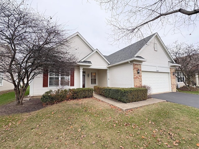 ranch-style house featuring aphalt driveway, brick siding, roof with shingles, a garage, and a front lawn