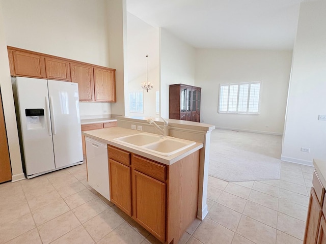 kitchen featuring white appliances, light countertops, a sink, and light tile patterned floors