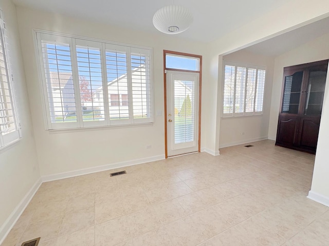 doorway to outside with visible vents and baseboards