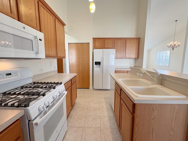 kitchen featuring brown cabinetry, white appliances, and a sink