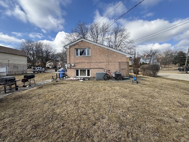 view of home's exterior featuring a yard and brick siding