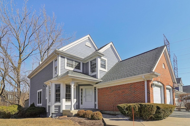 view of front of home featuring brick siding, entry steps, a garage, and roof with shingles