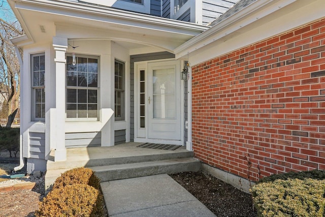 doorway to property with brick siding