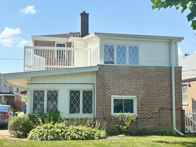 2820 W 84th St, Chicago, IL 60652 - rear view of house featuring a balcony, brick siding, and a chimney