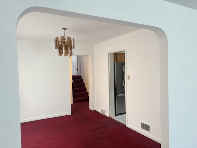 2820 W 84th St, Chicago, IL 60652 - hallway featuring arched walkways, carpet flooring, a chandelier, and stairway