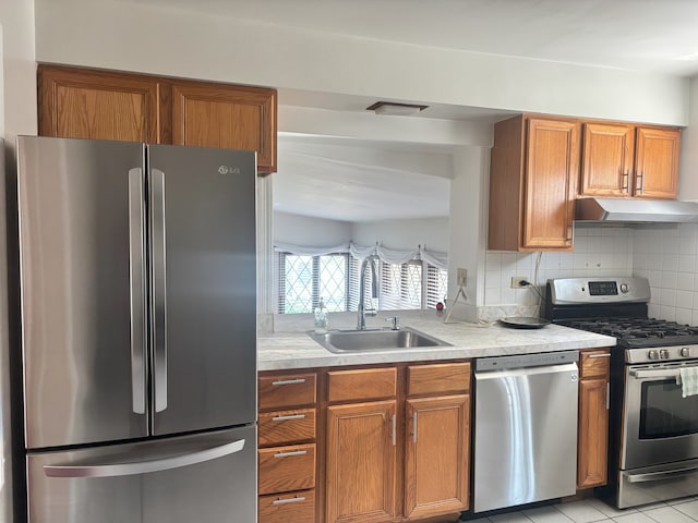 2820 W 84th St, Chicago, IL 60652 - kitchen with appliances with stainless steel finishes, under cabinet range hood, brown cabinetry, and light countertops
