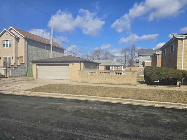 exterior space with a fenced front yard, an outbuilding, and driveway