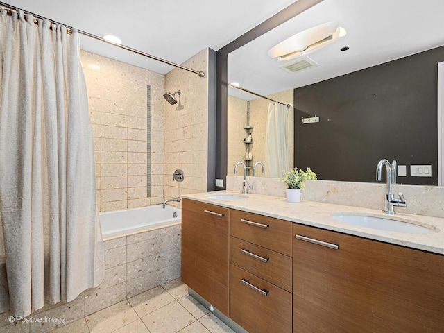 full bath featuring tiled shower / bath combo, tile patterned flooring, a sink, and visible vents