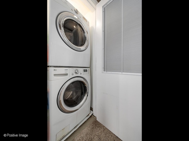 washroom featuring laundry area and stacked washer / dryer