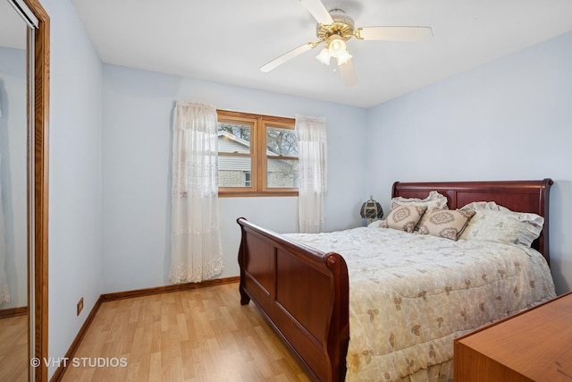 bedroom featuring light wood-type flooring, baseboards, and a ceiling fan