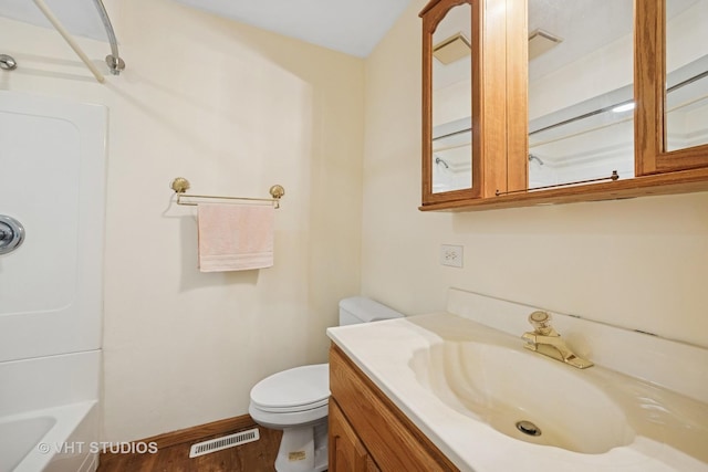 full bathroom with toilet, wood finished floors, vanity, visible vents, and baseboards