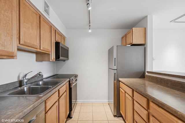 kitchen with light tile patterned floors, dark countertops, visible vents, appliances with stainless steel finishes, and a sink