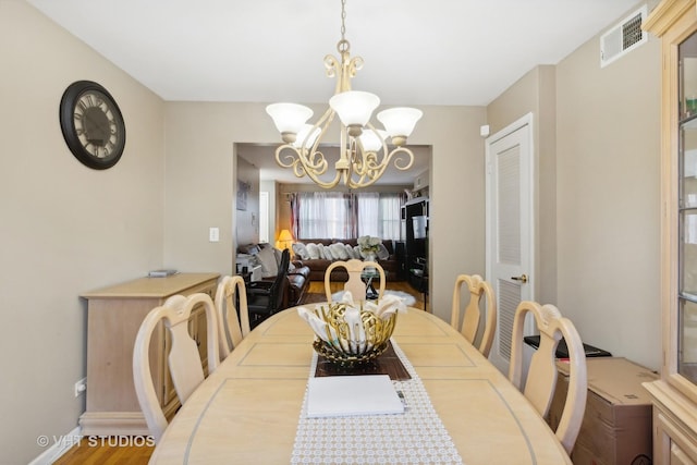7311 N Ashland Blvd Unit 2A, Chicago, IL 60626 - dining room featuring a chandelier and wood finished floors