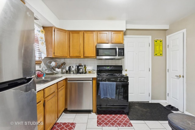 7311 N Ashland Blvd Unit 2A, Chicago, IL 60626 - kitchen with appliances with stainless steel finishes, light countertops, tasteful backsplash, and light tile patterned floors