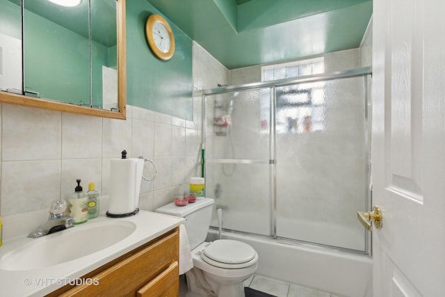 7311 N Ashland Blvd Unit 2A, Chicago, IL 60626 - full bathroom featuring tile walls, bath / shower combo with glass door, and vanity