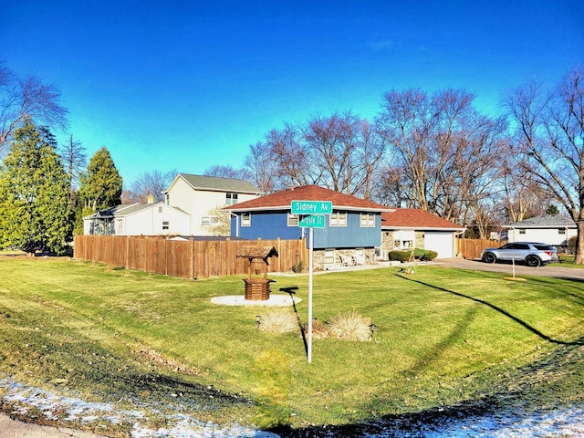 view of front of house with a front yard and fence