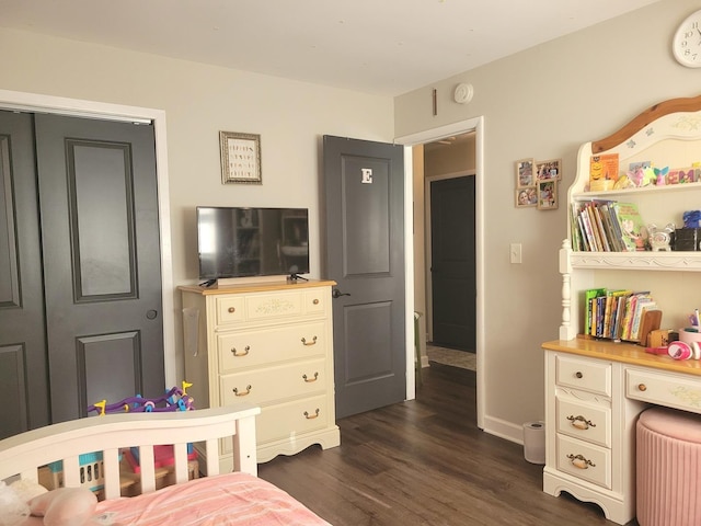 bedroom featuring baseboards and dark wood-type flooring