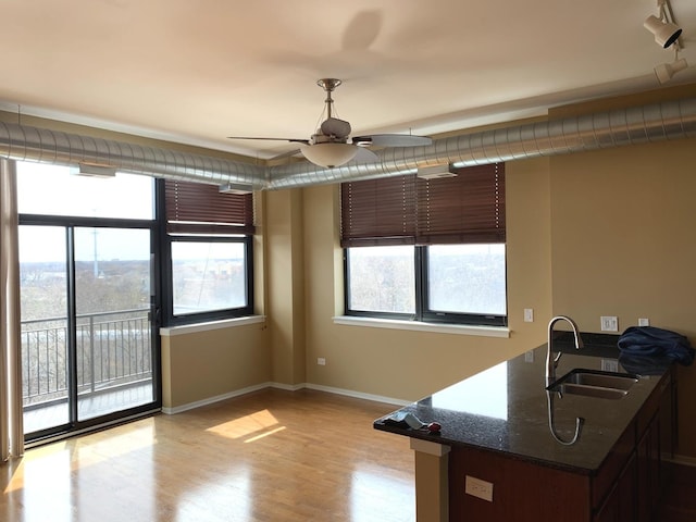 dining room with a ceiling fan, baseboards, and light wood finished floors