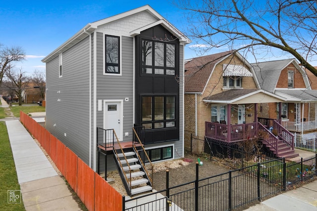 view of front of house with a fenced front yard and stairway