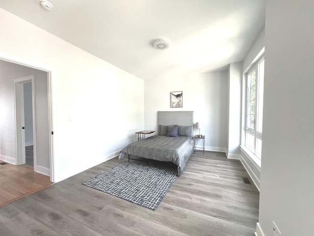 bedroom featuring baseboards and wood finished floors