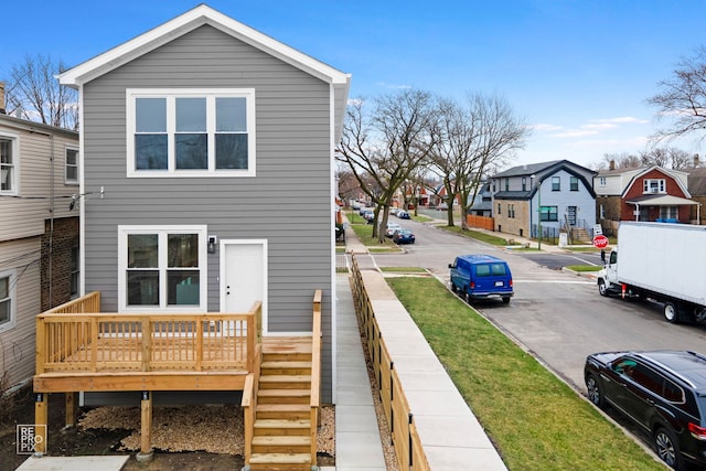 rear view of house with a residential view and a deck