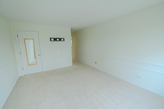 unfurnished room featuring light colored carpet