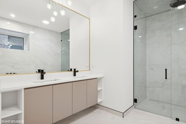 bathroom with double vanity, a sink, and a shower stall