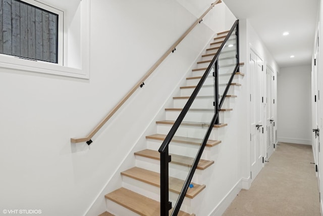 stairs with carpet floors, baseboards, and recessed lighting