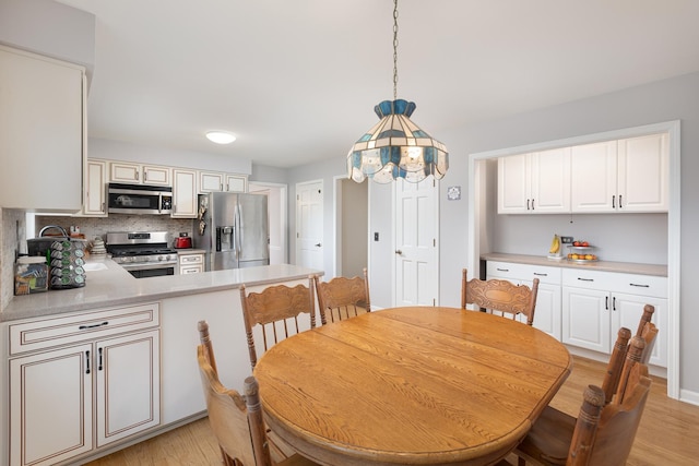 dining space with light wood-type flooring